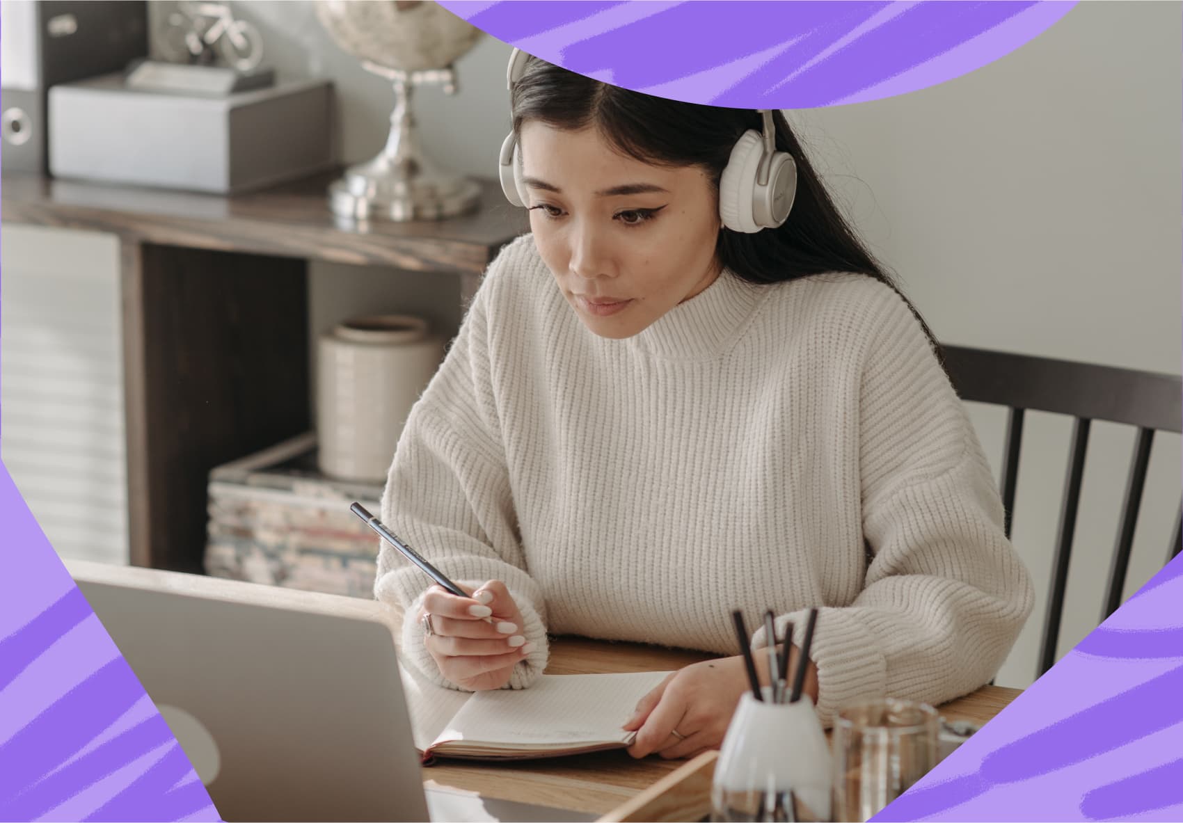 Woman with headphones on looking at computer screen