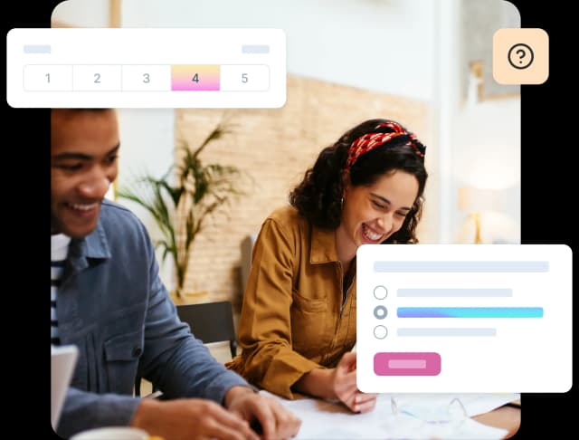 Two people smiling and working together on market research.